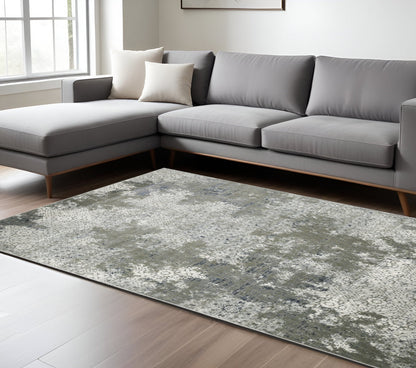 6' X 9' Ivory Grey Blue And Taupe Abstract Power Loom Stain Resistant